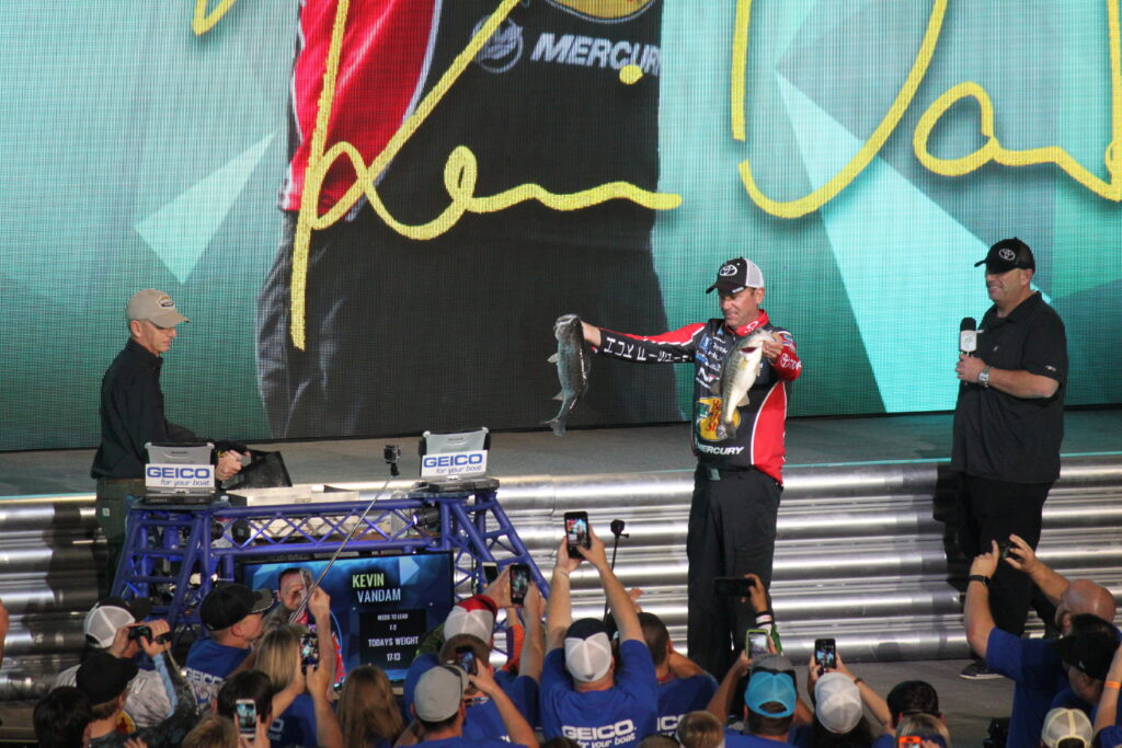 Kevin VanDam presenting a bass on the 2017 Bassmaster Classic weigh-in stage