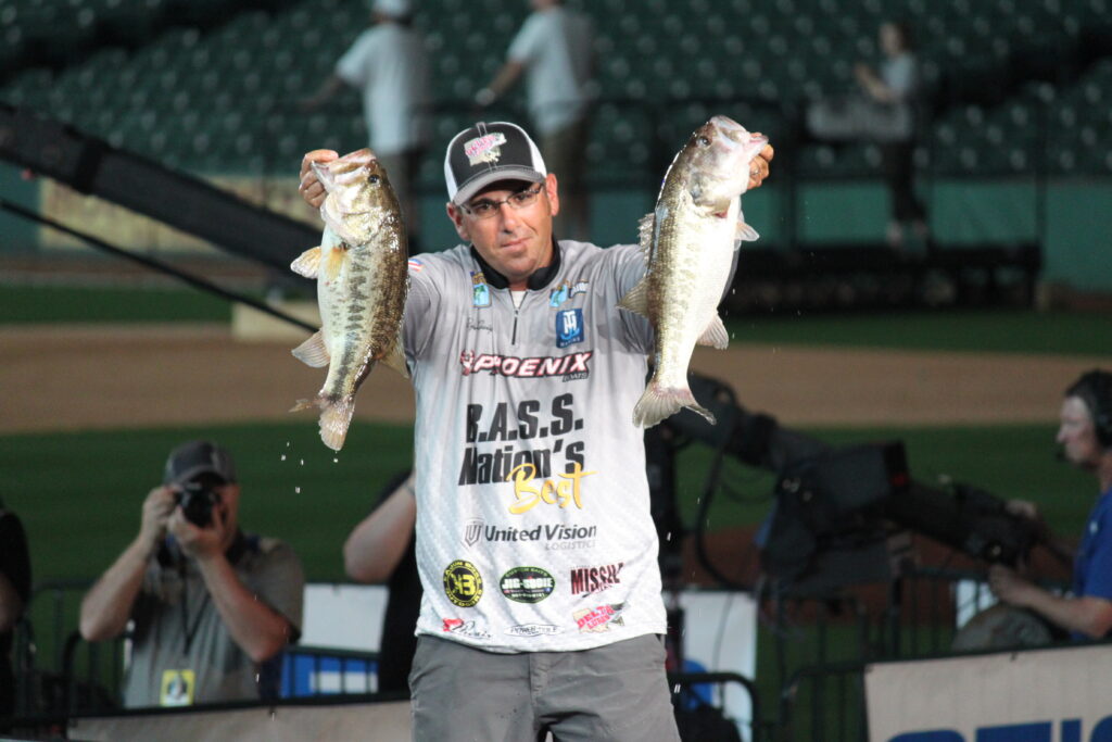 Bassmaster Classic competitor holding two largemouth bass