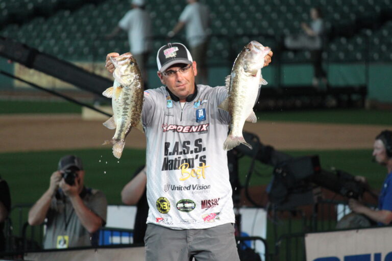 Bassmaster Classic competitor holding two largemouth bass