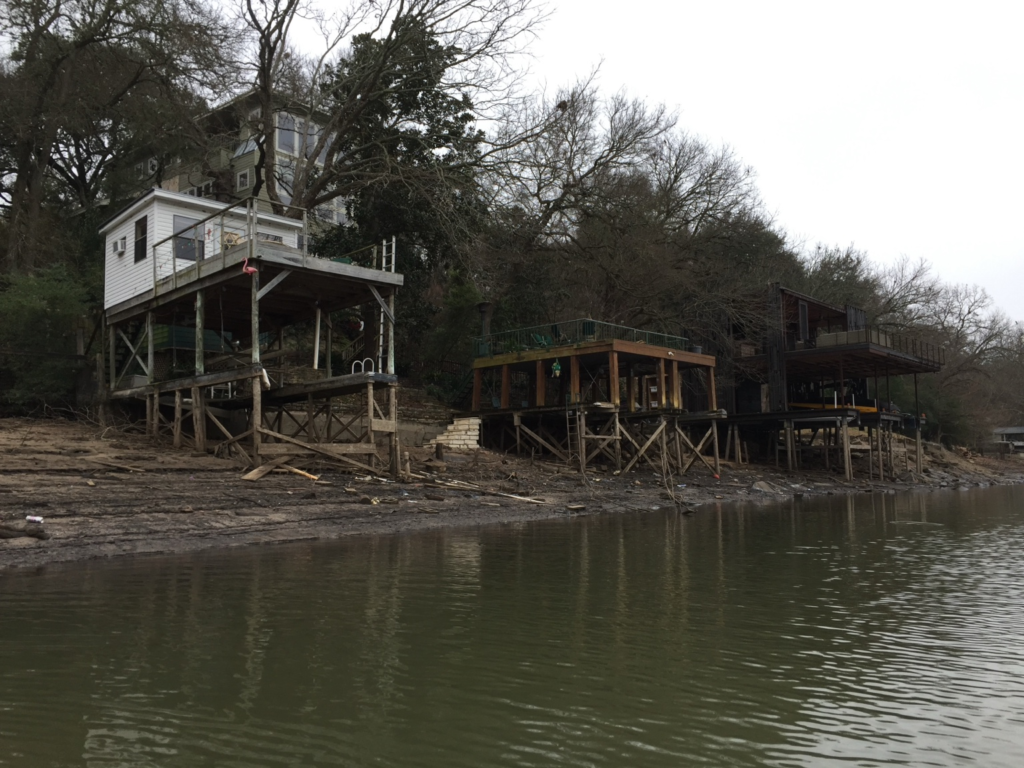Lakeside homes and docks exposed by very low reservoir water levels