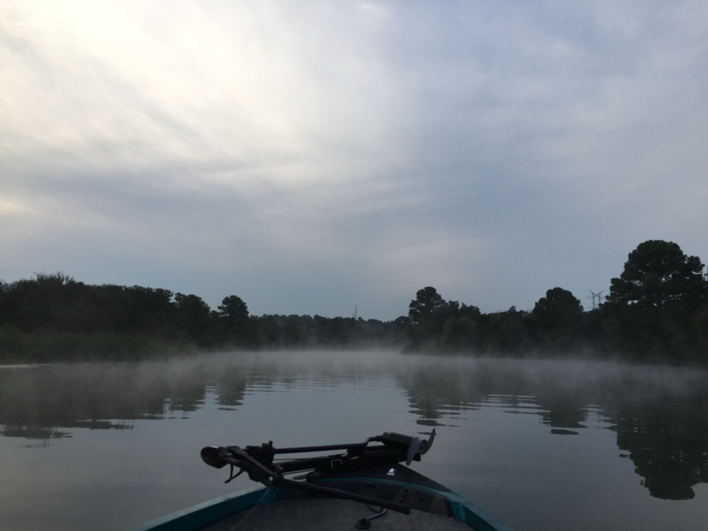 Bass fishing from a boat on a misty morning