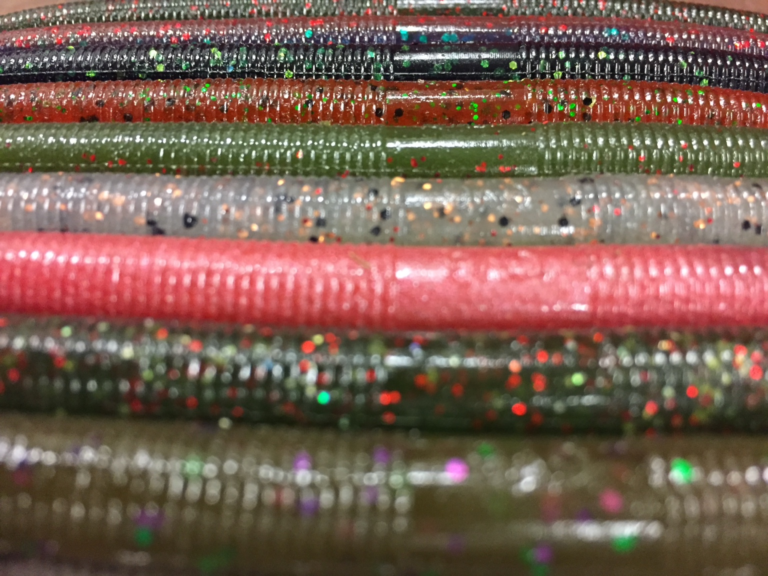 Assorted stick worms in multiple colors and flake patterns